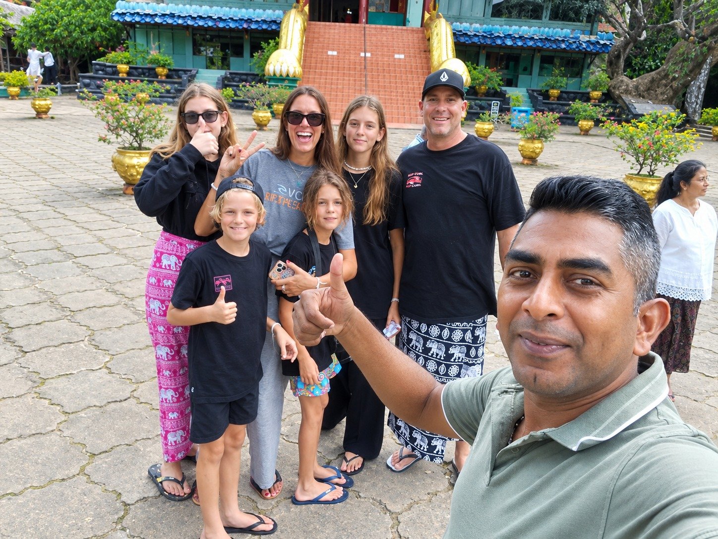 JK Tours travelers visiting a historic Sri Lankan temple with their private guide
