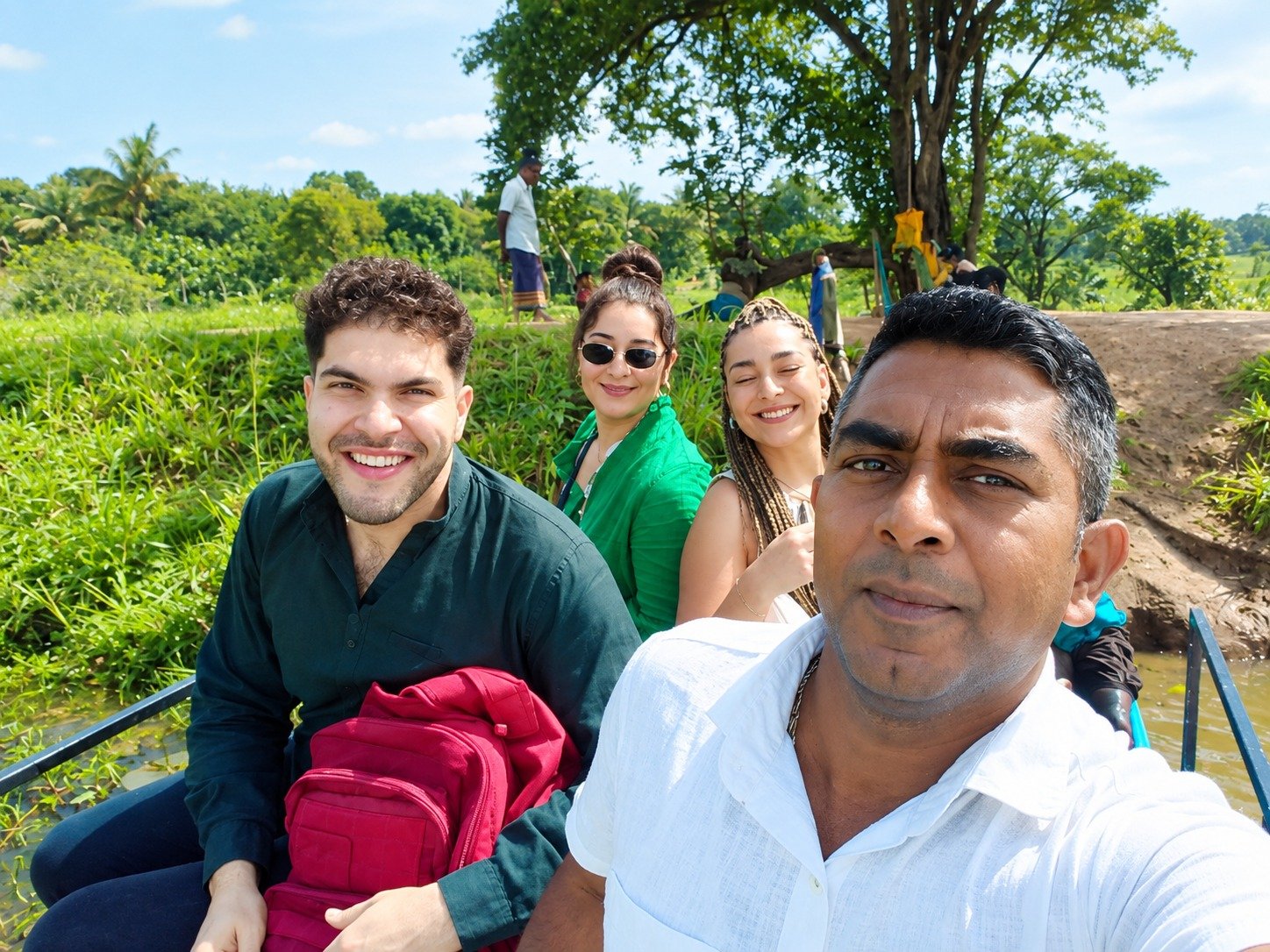 JK Tours guests enjoying a catamaran lake boat safari in Sri Lanka surrounded by water lilies