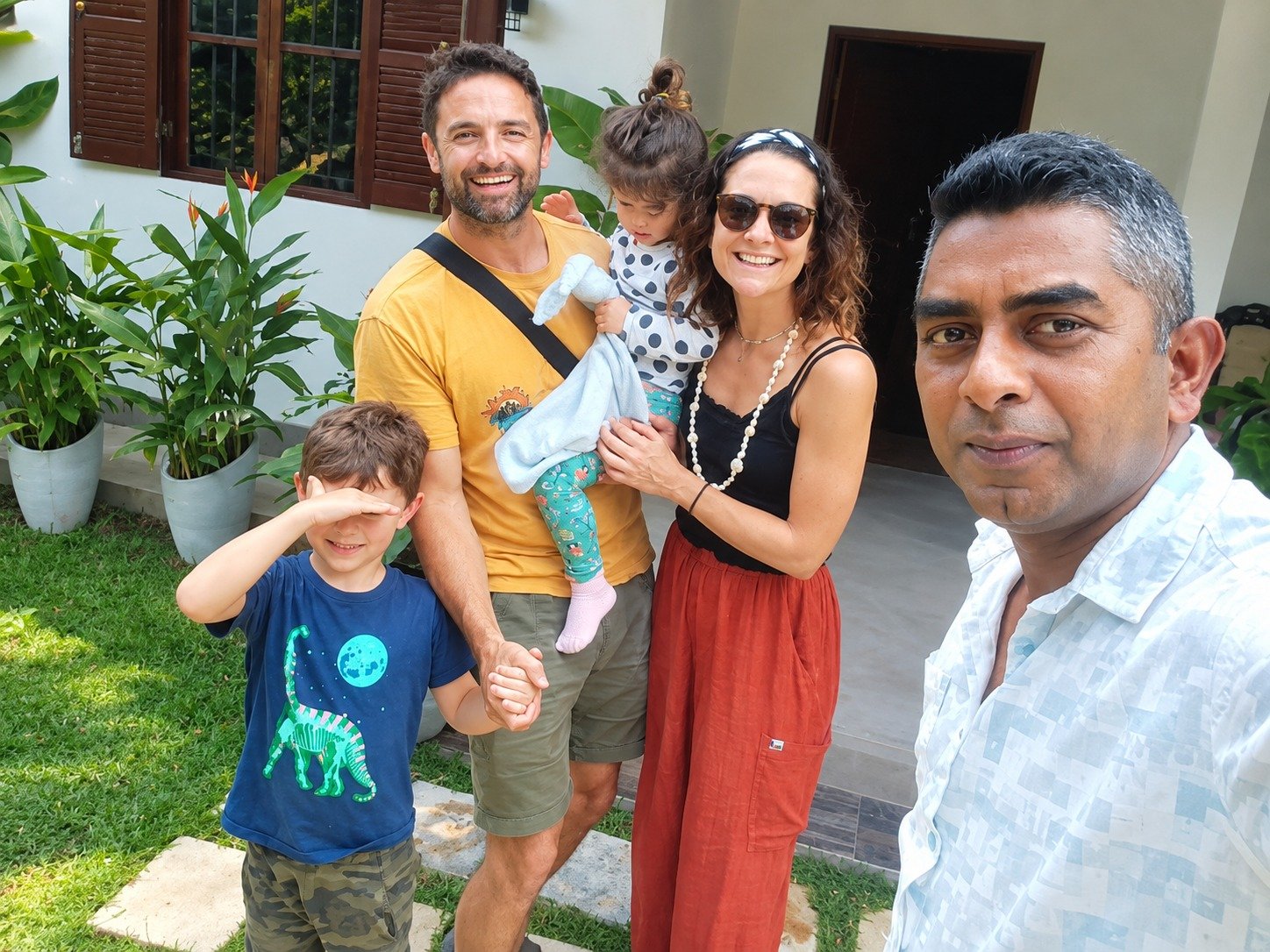 Happy family with kids relaxing at their private villa stay