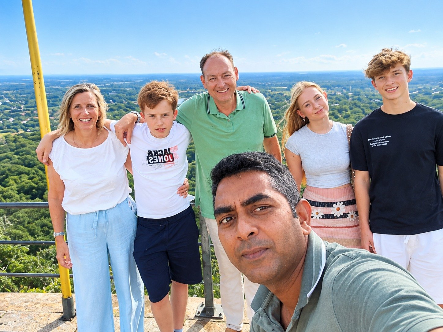 JK Tours guests and private chauffeur at the summit of Sigiriya Rock Fortress overlooking panoramic jungle vistas